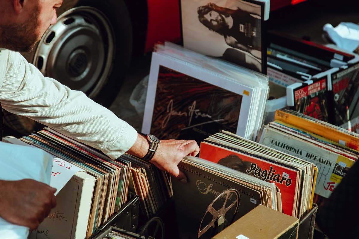 Hands flicking through a crate of second-hand records