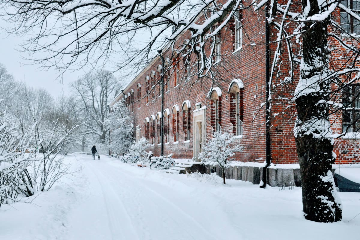 A red-brick building and a snowy path in Helsinki